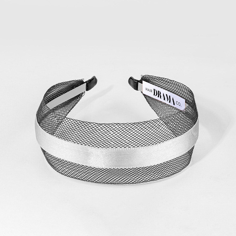 Black mesh headband with white satin band on a light gray background